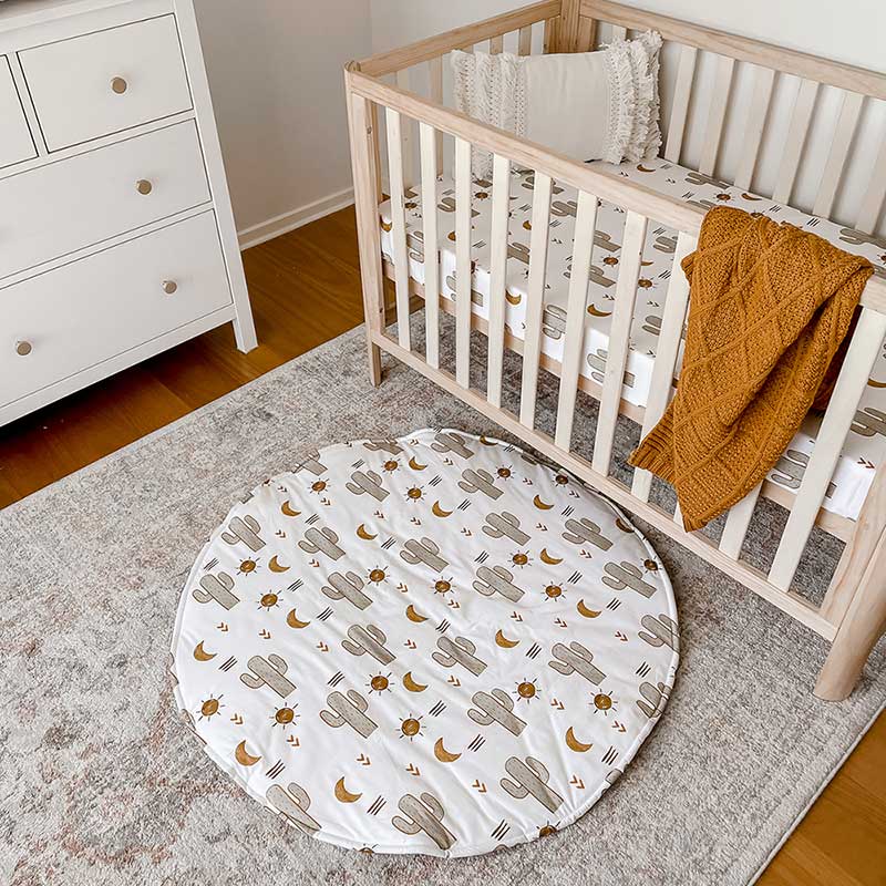 Snuggly Jacks Nursery featuring baby cot with an Arizona Fitted Cot sheet and Honey Knitted Blanket. Arizona Round Playmat on the ground