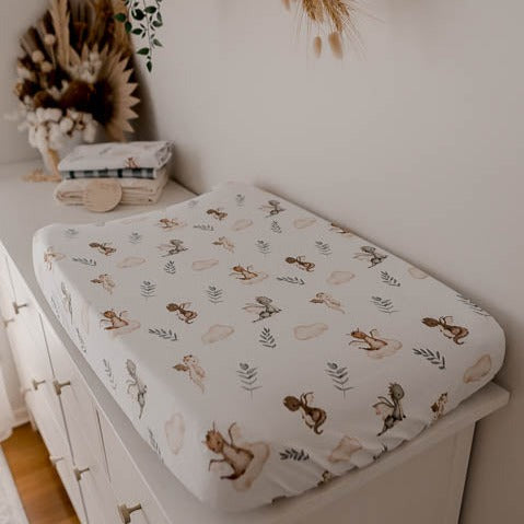 Change mat cover with dragons, leaves and clouds. The print is found in earthy browns, cinnamons and greens, great for a mother's modern nursery design.