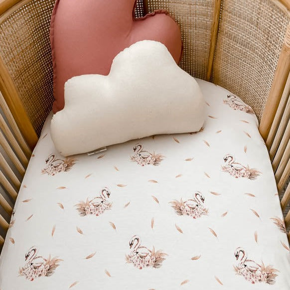 close up shot of a Snuggly Jacks Australia bassinet sheet in a rattan bassinet 