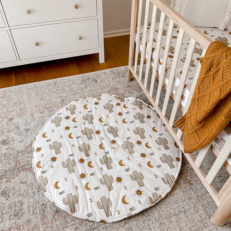 Baby Nursery with Snuggly Jacks Round Playmat on the ground.