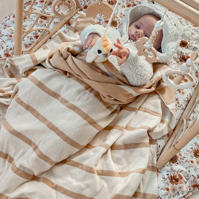 A warm and breathable cotton knitted blanket in beige and brown striped pattern from Snuggly Jacks, a premium Australian brand of knitted blankets and throws