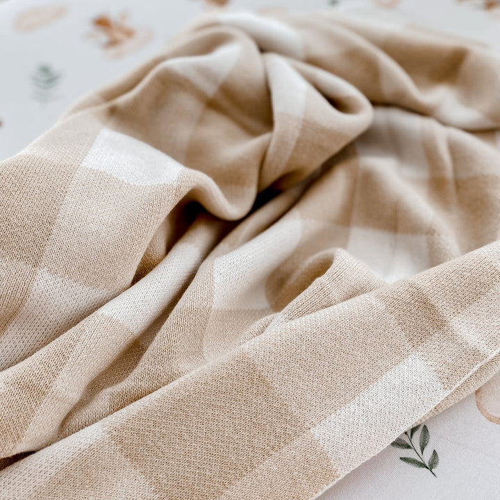 Detailed view of sand gingham knitted baby blanket in organic cotton, showcasing its soft and breathable texture