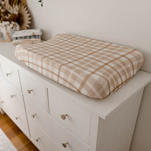 Earthy Plaid Bassinet Sheet / Change Mat Cover set on top of a white pine chest of draws