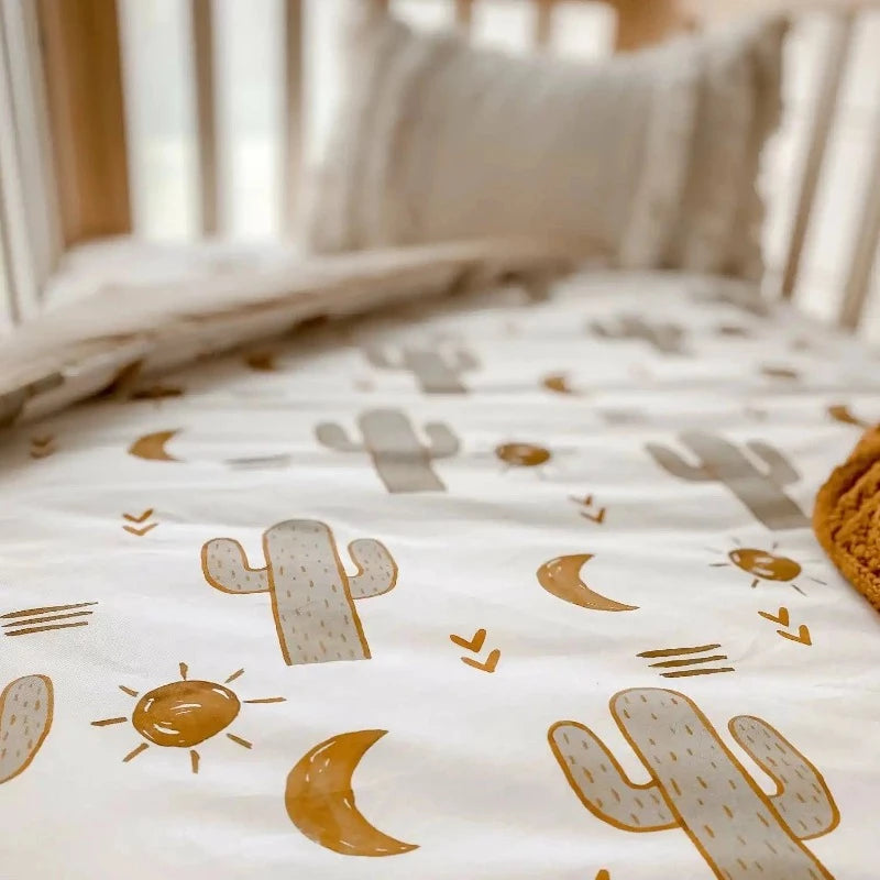Neutral colors and prints on a cotton quilt, including a cotton knitted blanket perfect for warm weather and breathable layers, Cot Size available in Australia