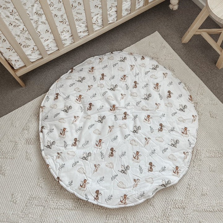 Over head shot of a whimsical dragon printed play mat set out on the floor 