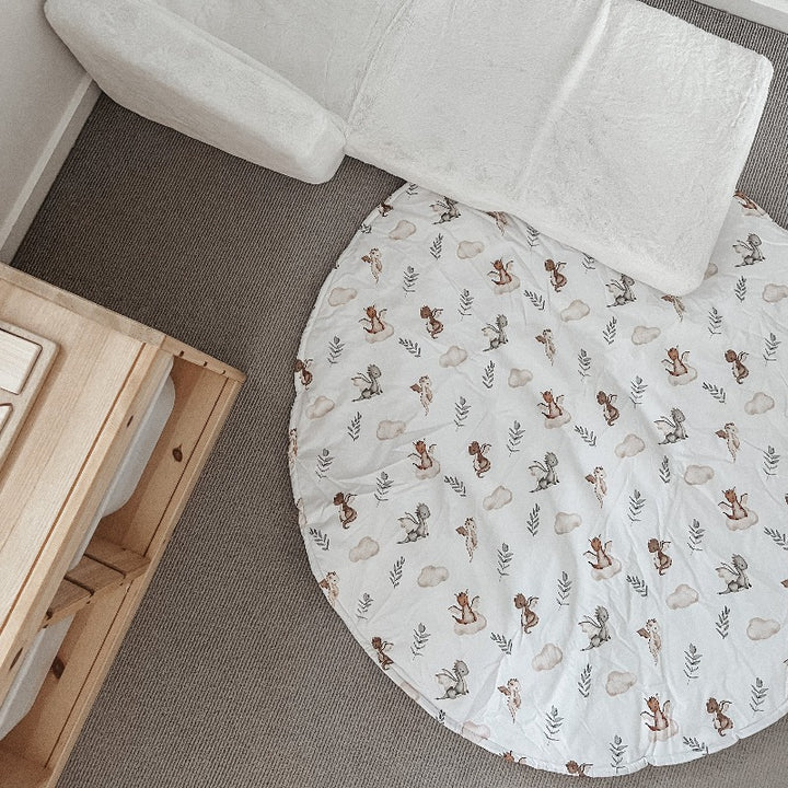 Over head shot of a playmat set out under a plush fold out chair on a grey carpet.