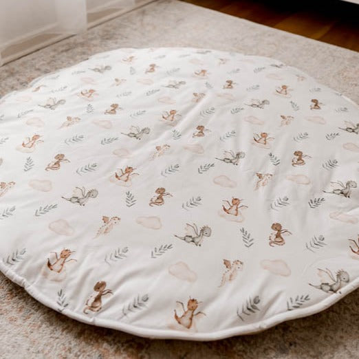 Cotton Playmat with a dragons, leaves and clouds in a seemless pattern set out on a floor rug