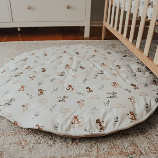 An image of snuggly jacks mystique dragon play mat laid out on the floor of a nursery