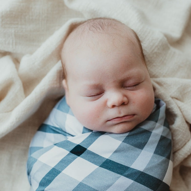 Close up of a baby all wrapped up in a jersey cotton blend stretch wrap from snuggly jacks