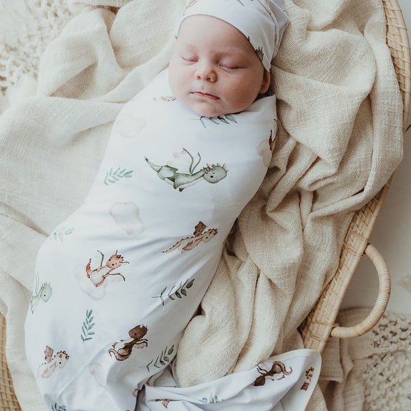 Sweet little baby all snuggled in a jersey swaddle wrap in a dragon print