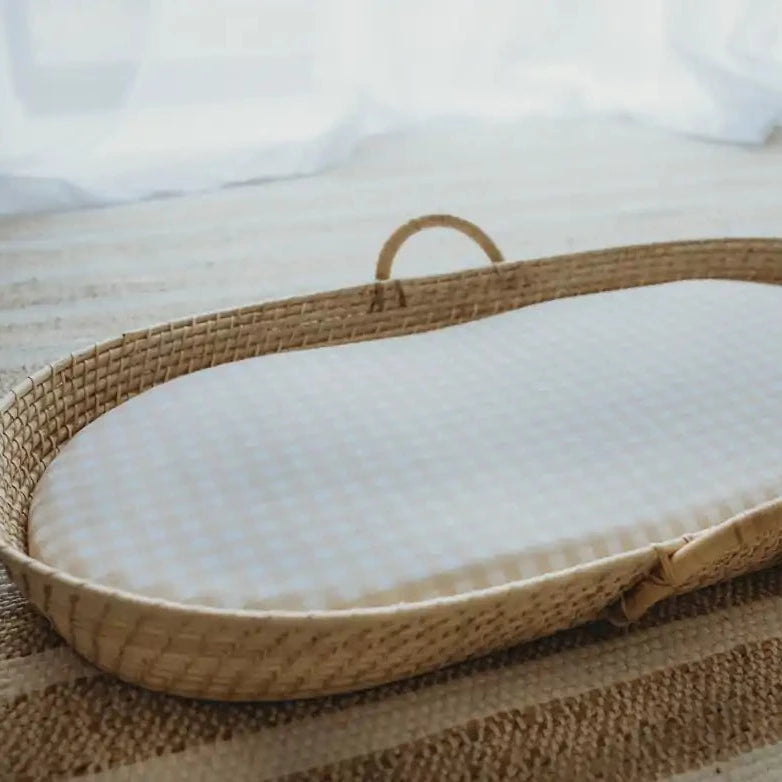 Moses bassinet net made from ratan with the sand gingham change table mat cover which doubles as bassinet sheets.