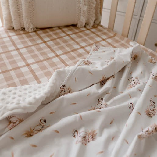 Pine cot made with a 100% cotton sheet fitted sheet and a white swan printed dimple dot minky
