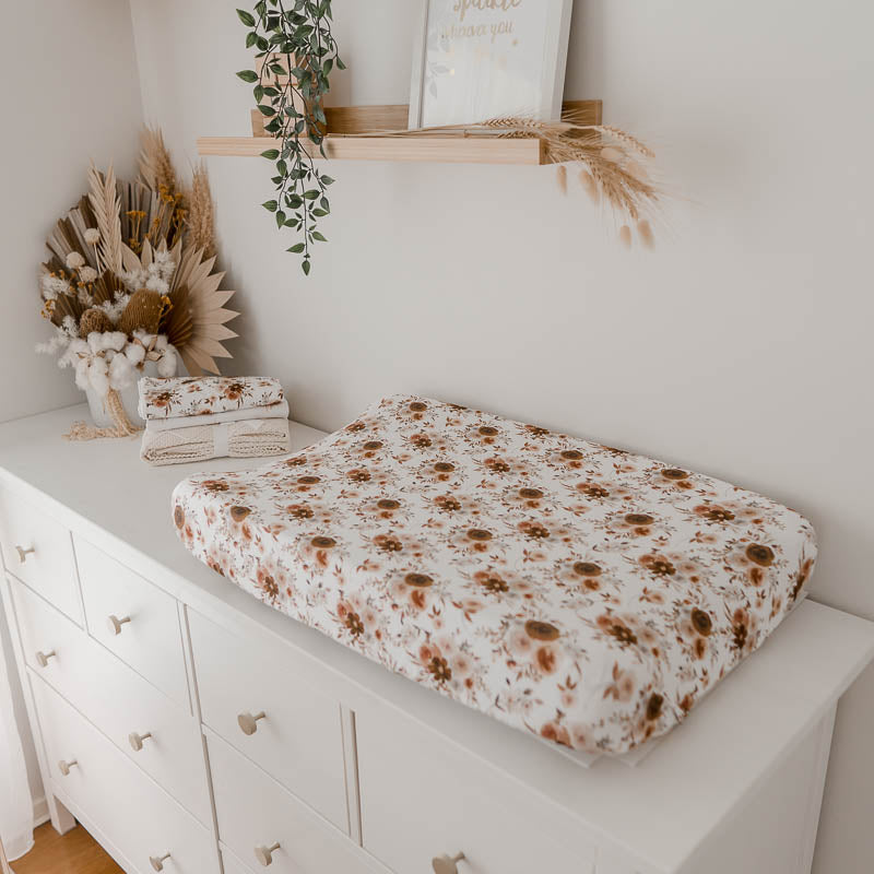 White pine chest of draws with a floral change mat in the foreground 
