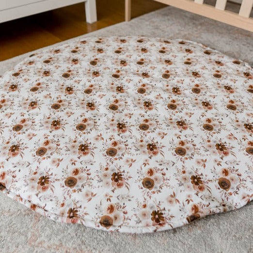 An image of snuggly jacks willow floral play mat laid out on the floor of a nursery